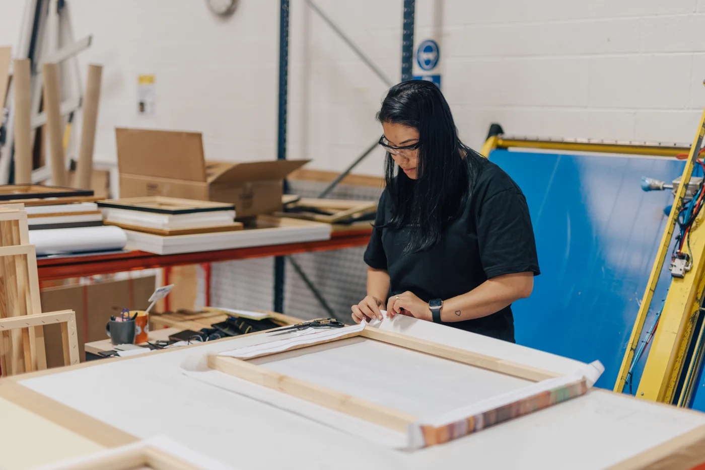 A Print Clever specialist finishing and checking a canvas