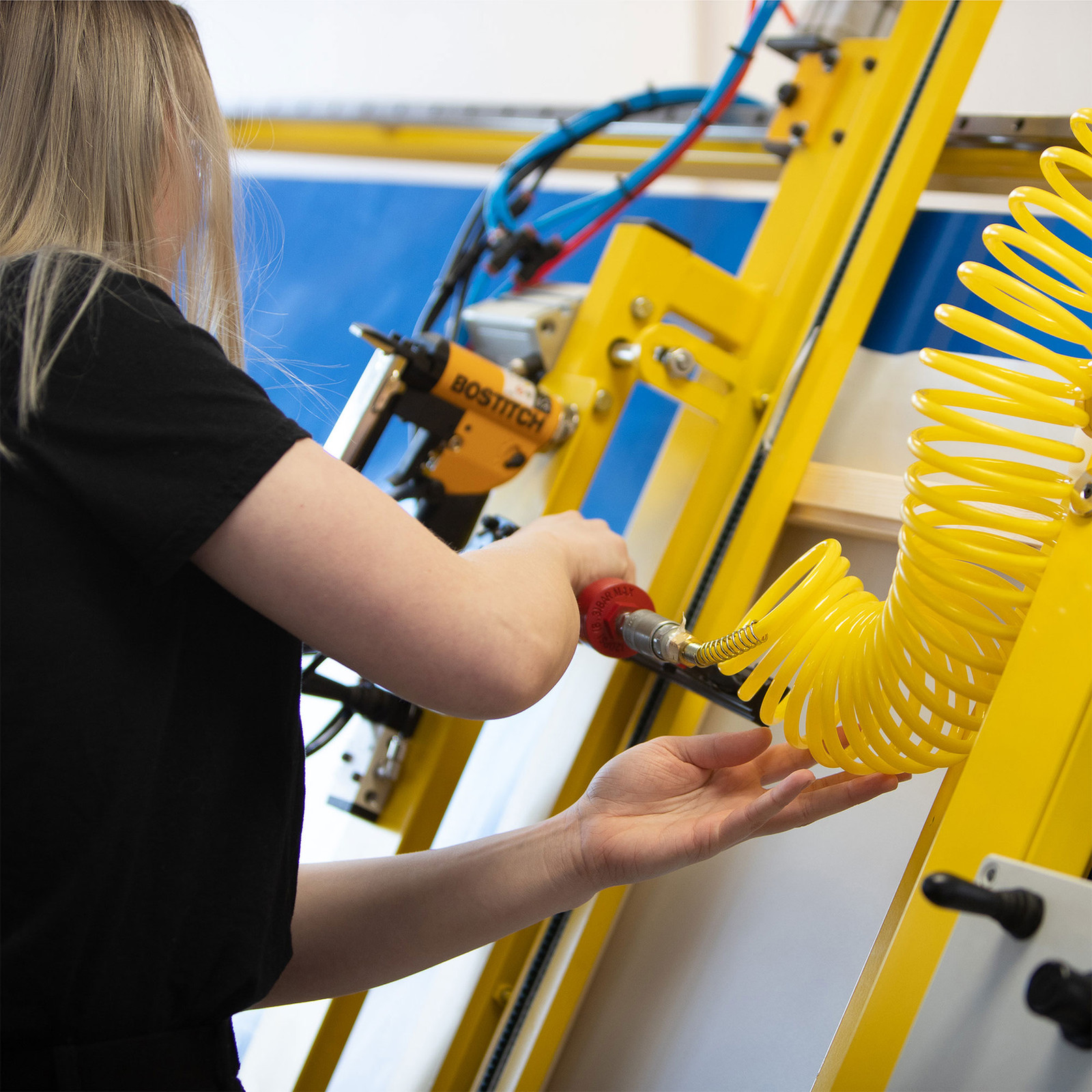 A Print Clever specialist working with framing equipment
